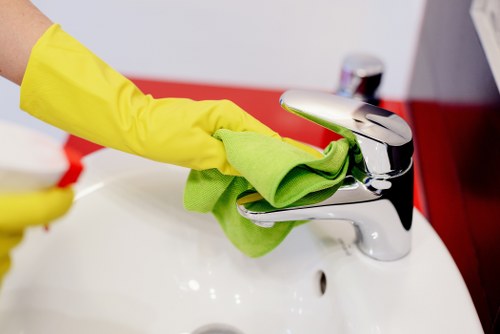 Cleaner inspecting carpet cleaning equipment before starting work
